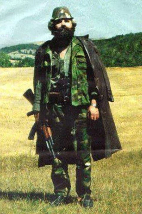 Adem Jashari, leader of the Kosovo Liberation Army, withstood for three days (and intermittently for the seven years prior) the brunt of the Serbian military police. His family and he were surrounded early on the Fifth of March in 1998, and refused to surrender. He would be found with a bullet in the throat, killed during the subsequent attack on his family's property, extensive to the point of involving tanks, mortar, and sniper fire. Later reports would show that the operation intended not on apprehending members of the armed Albanian resistance, but annihilating them and their families.
